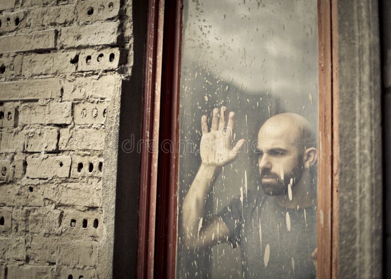 sad-man-nostalgia-looking-out-window-67523943.jpg